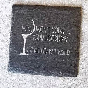 Slate remnant, made into a square coaster, with silver writing "wine won't solve your problems,  but neither will water".